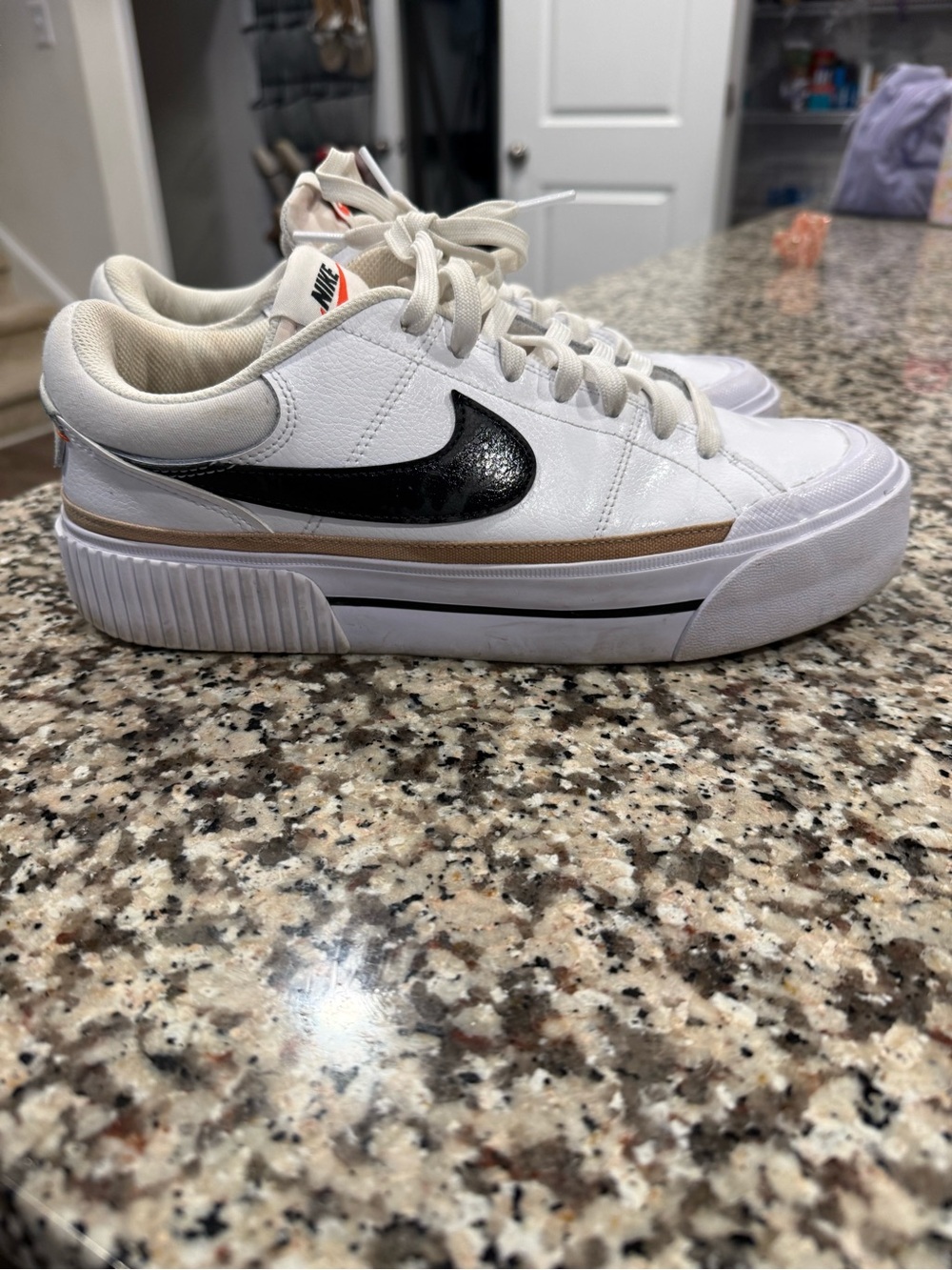 Nike White Low-Top Sneakers with Black Swoosh and Brown Accent
